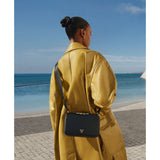 Tumi Voyageur Leather Myla Crossbody bag with adjustable strap and multiple compartments, stylish and functional for everyday use.