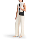 Tumi Voyageur leather Myla crossbody bag with adjustable strap and multiple compartments, designed for stylish everyday use.