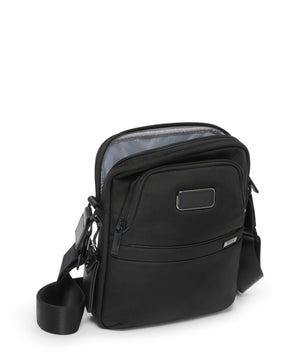 Tumi Alpha medium crossbody bag with adjustable strap and multiple compartments, made of durable black nylon material.