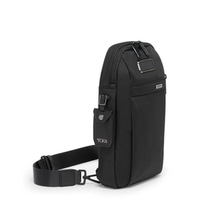 Tumi Alpha sling bag with adjustable strap, compact design, and multiple compartments for travel and everyday use.