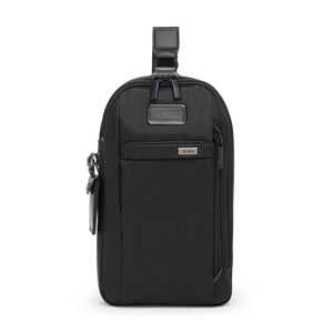 Tumi Alpha sling bag shown with adjustable strap, compact design, and multiple compartments for convenient carrying.