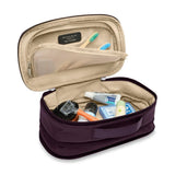 Briggs & Riley Baseline expandable toiletry kit with multiple compartments and zipper closures for travel organization.