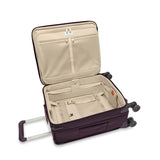 Briggs & Riley Baseline Global Carry-On Spinner luggage in blue with four wheels and telescopic handle.