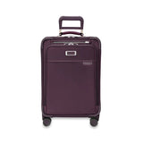Briggs & Riley Baseline Essential Carry-On Spinner luggage in blue with four wheels and a telescoping handle for easy travel.
