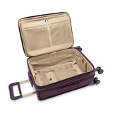 Briggs & Riley Baseline Essential Carry-On Spinner luggage in blue with four wheels and telescopic handle for travel.