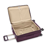Briggs & Riley Baseline medium expandable spinner suitcase with blue hard shell exterior and four spinner wheels.