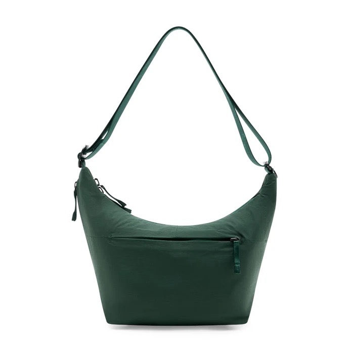 Peak Design City Crescent 6L travel bag in Cypress green with multiple compartments and adjustable straps.