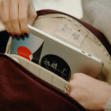 Peak Design City Backpack 15L shown in a lifestyle setting, featuring multiple compartments, padded straps, and sleek urban style.