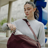Peak Design City Backpack 15L in gray, shown with multiple compartments, padded straps, and a sleek urban design for everyday use.