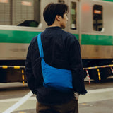 Peak Design City Crescent 6L compact travel bag shown in a lifestyle setting with multiple compartments and adjustable straps.