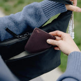 Peak Design City Crescent 6L backpack shown in lifestyle setting with sleek black fabric and compact, functional design.