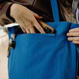 Peak Design City Tote in black, showing the spacious interior with multiple compartments and stylish exterior for urban use.