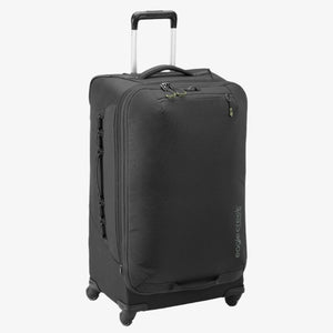 Eagle Creek Expanse 4-wheel 30-inch suitcase with black hard shell exterior and telescopic handle for easy rolling.
