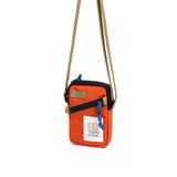 Topo Designs mini shoulder bag with adjustable crossbody strap, front pocket, and durable fabric in earthy tones.