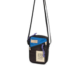 Topo Designs mini shoulder bag, crossbody style, with adjustable strap and durable fabric, shown in a close-up view.