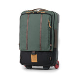 Topo Designs Global Travel Bag roller, black carry-on luggage with four wheels and a telescoping handle, designed for travel.