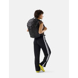 Matador 24L Adventure Pack in black, featuring multiple compartments, durable fabric, and adjustable straps for outdoor travel.