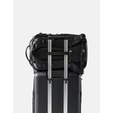 Matador 24L Adventure Pack in black showing durable, compact design with adjustable straps and multiple compartments for outdoor use.