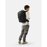 Black Matador 35L Global Travel Pack with multiple compartments and padded straps, designed for comfortable travel.