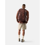 Matador 35L Global Travel Pack in garnet, showing compact design with adjustable straps and multiple compartments for travel.