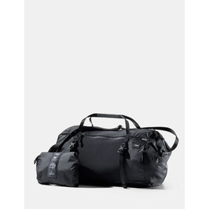 Black Matador 30L packable duffel bag laid flat, showing its compact, lightweight design and durable material.