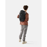 Black Matador 30L packable duffel bag shown folded and expanded, highlighting its compact design and versatile carry features.
