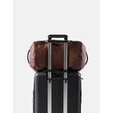 Red Matador 30L packable duffel bag shown folded and partially unfolded, highlighting its compact and lightweight design.