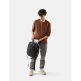Black Matador 18L personal item travel pack with sleek design and compact size, ideal for carry-on luggage and travel essentials.