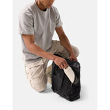 Matador 24L Tote Pack in black, showing a compact, lightweight waterproof tote bag with sturdy handles and sleek design.