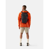Black Matador 18L waterproof packable backpack shown folded and partially unfolded, lightweight and compact for outdoor use.