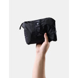 Matador waterproof packable backpack in black, 18L capacity, shown folded and unfolded for compact storage and outdoor use.