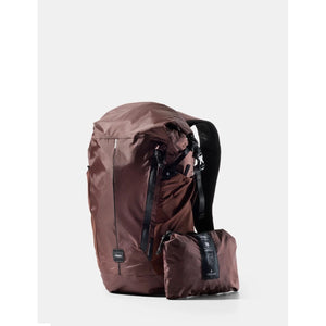 Matador 18L waterproof packable backpack in garnet color, shown folded and expanded, with adjustable shoulder straps.