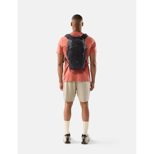 Black Matador 18L packable backpack folded and partially unfolded, showcasing lightweight, compact design for travel and outdoor use.