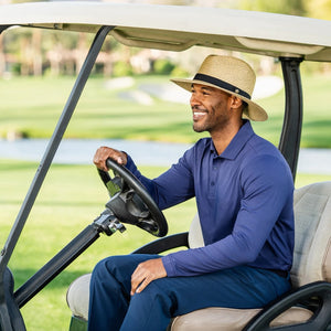 Wallaroo Hat Company Palmer UPF 30+ packable hat in natural color, shown in a lifestyle outdoor setting.