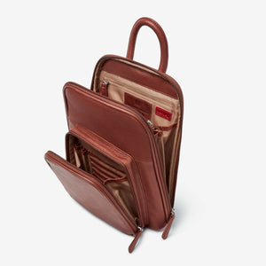 Osgoode Marley small organizer backpack in brandy color showing side view with multiple compartments and adjustable straps.