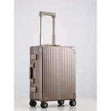 Silver Aleon 21-inch aluminum international carry-on suitcase with smooth surface and sturdy handle, ready for travel.