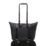 Baggallini Carryall expandable tote bag in neutral fabric, showing its spacious design and sturdy handles.