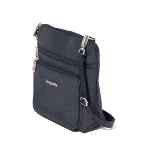 Navy Baggallini Modern Pocket Crossbody bag with multiple compartments and adjustable strap, showcasing sleek, functional design.