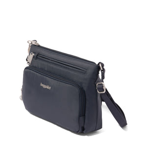 Baggallini Securtex anti-theft keepsake crossbody bag in French navy with secure zipper and compact design.