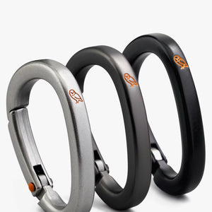 Bellroy Carabiner Trio set featuring black, graphite, and silver metal carabiners for versatile gear organization and attachment.