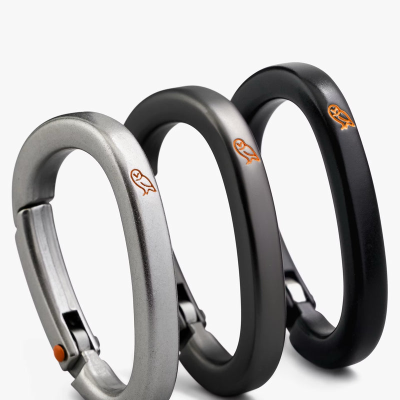 Bellroy Carabiner Trio set featuring black, graphite, and silver metal carabiners for versatile gear organization and attachment.