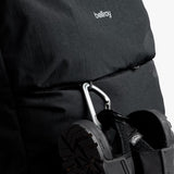 Bellroy Lite Travel Pack 38L backpack shown with multiple compartments, padded straps, and sleek black design for travel convenience.