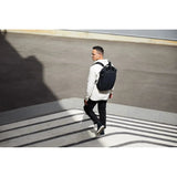 Bellroy Tokyo Totepack backpack showing its sleek black exterior and adjustable shoulder straps for versatile carrying.