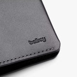 Black Bellroy passport cover with snug fit and multiple card slots, made from premium leather for stylish travel organization.