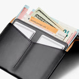Black Bellroy passport cover with sleek leather design and multiple card slots, designed to protect and organize your travel documents.