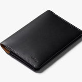 Black Bellroy passport cover with sleek design and multiple card slots, made from premium leather.