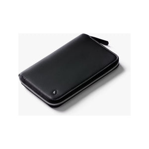Bellroy Travel Folio 2nd Edition open with passport, cards, and documents inside on a white background.