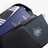 Bellroy Travel Folio 2nd Edition open with passport, boarding passes, and cards inside, showcasing organized travel wallet features.