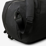 Bellroy Venture Duffel 55L in black, showing the spacious, durable travel bag with adjustable shoulder strap and multiple compartments.