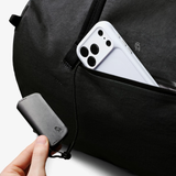 Bellroy Venture Duffel 55L in black, showing its spacious design, sturdy handles, and durable fabric for travel and storage.